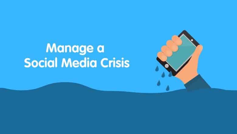 Hand lifting a phone displaying 'social media crisis' while drowning